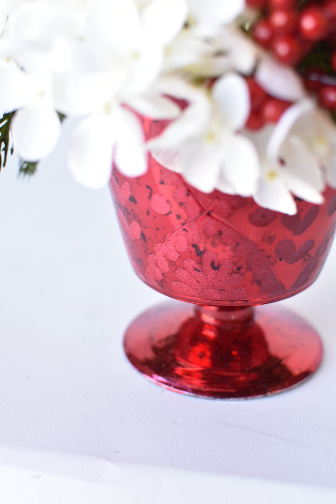 White Hydrangea + Greens in Red Glass Container
