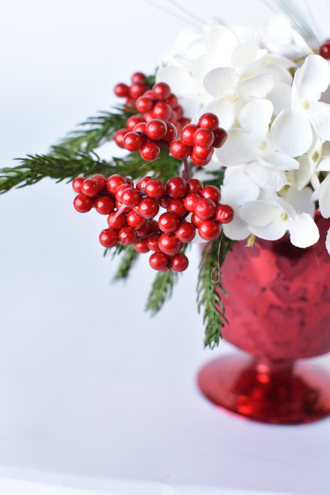 White Hydrangea + Greens in Red Glass Container